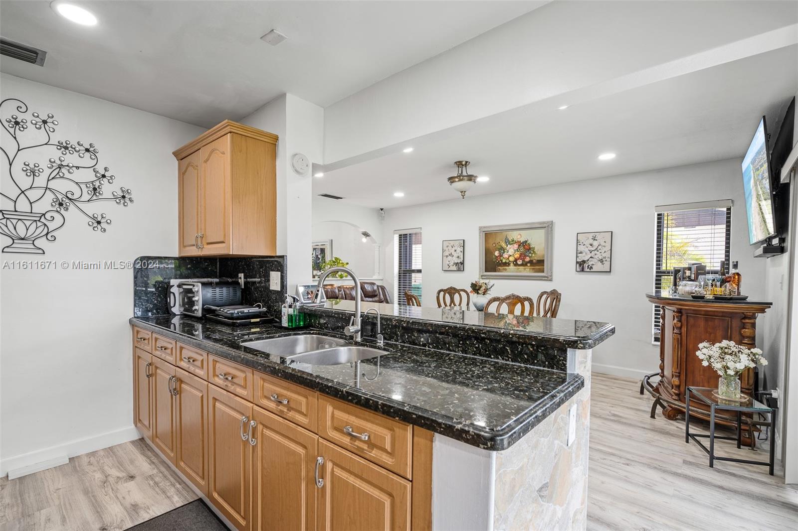11914 Southwest 125th Place Miami, FL 33186 - Photo 15 of 31 a kitchen with stainless steel appliances granite countertop a stove a sink and a microwave