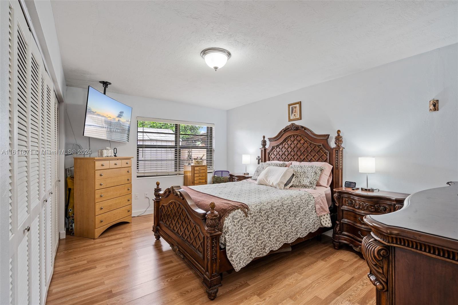11914 Southwest 125th Place Miami, FL 33186 - Photo 16 of 31 a bedroom with a bed and wooden floor