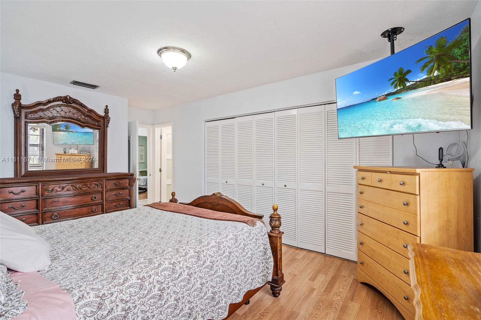 11914 Southwest 125th Place Miami, FL 33186 - Photo 18 of 31 a bedroom with a bed and a dresser