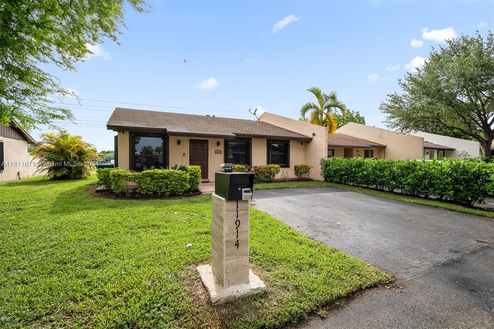 11914 Southwest 125th Place Miami, FL 33186 - Photo 2 of 31 a front view of a house with a yard