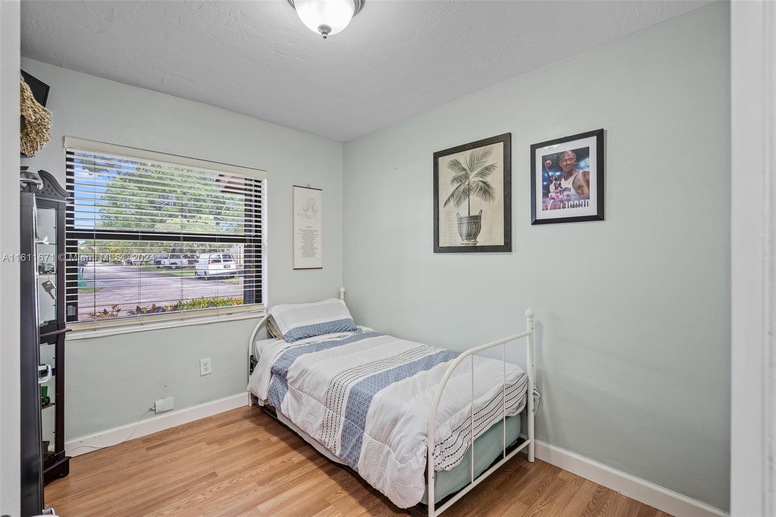 11914 Southwest 125th Place Miami, FL 33186 - Photo 21 of 31 a bedroom with a bed and a window
