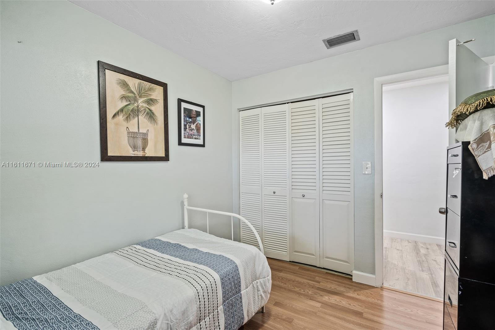 11914 Southwest 125th Place Miami, FL 33186 - Photo 22 of 31 a bedroom with a bed and a painting on the wall