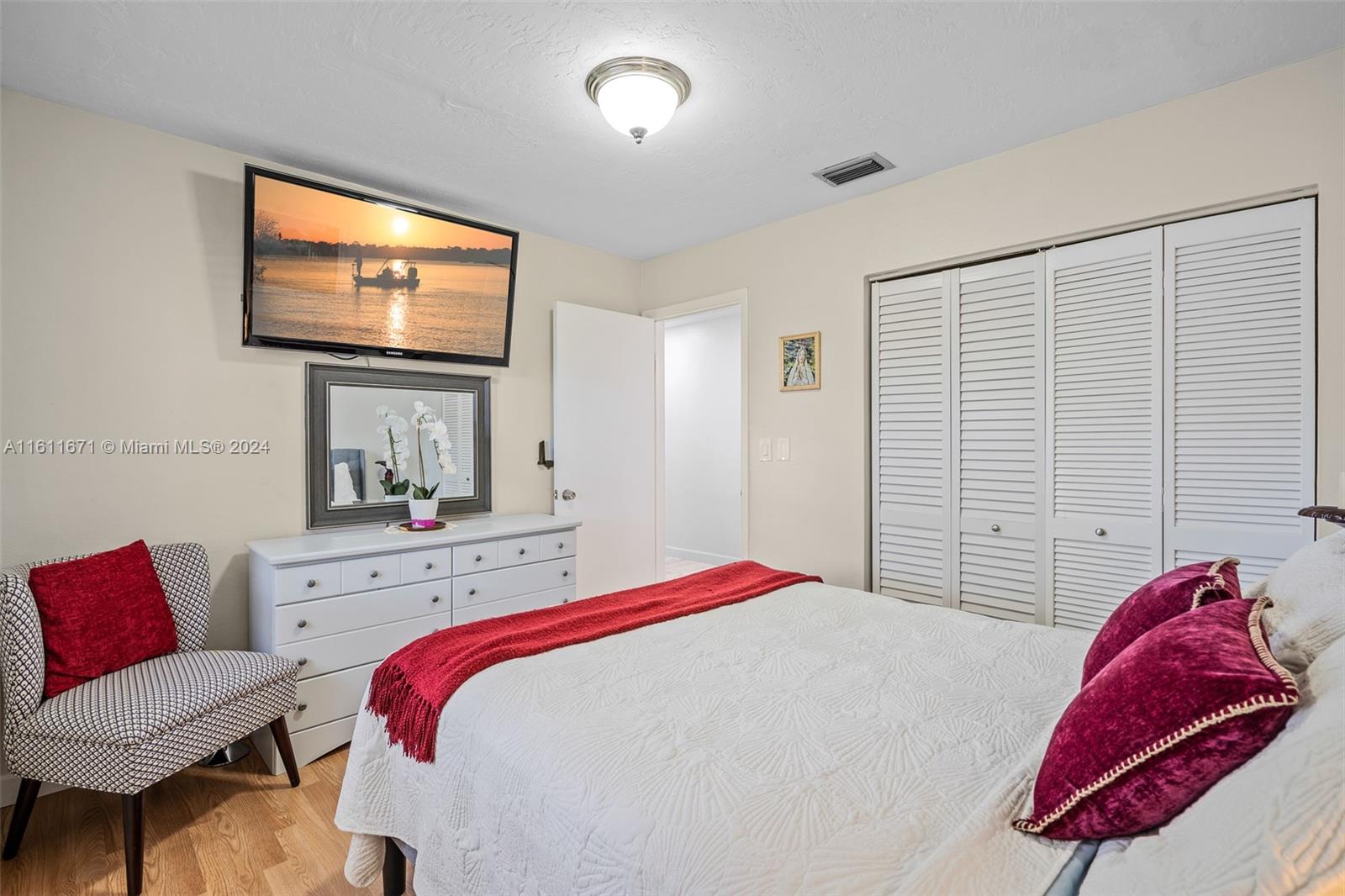 11914 Southwest 125th Place Miami, FL 33186 - Photo 24 of 31 a bedroom with a bed and a flat screen tv