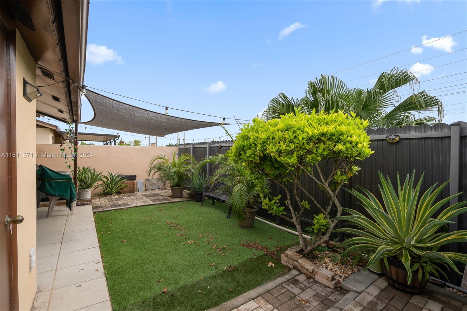 11914 Southwest 125th Place Miami, FL 33186 - Photo 27 of 31 a backyard of a house with a garden and outdoor seating