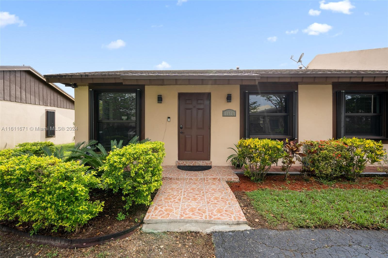 11914 Southwest 125th Place Miami, FL 33186 - Photo 3 of 31 a front view of a house with garden