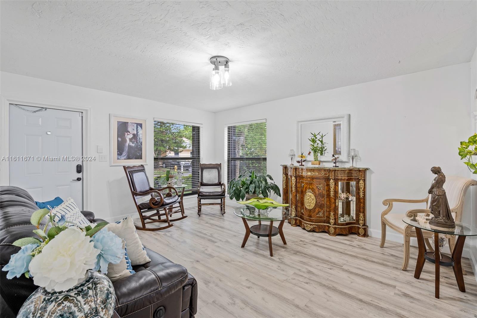 11914 Southwest 125th Place Miami, FL 33186 - Photo 4 of 31 a living room with furniture and a wooden floor