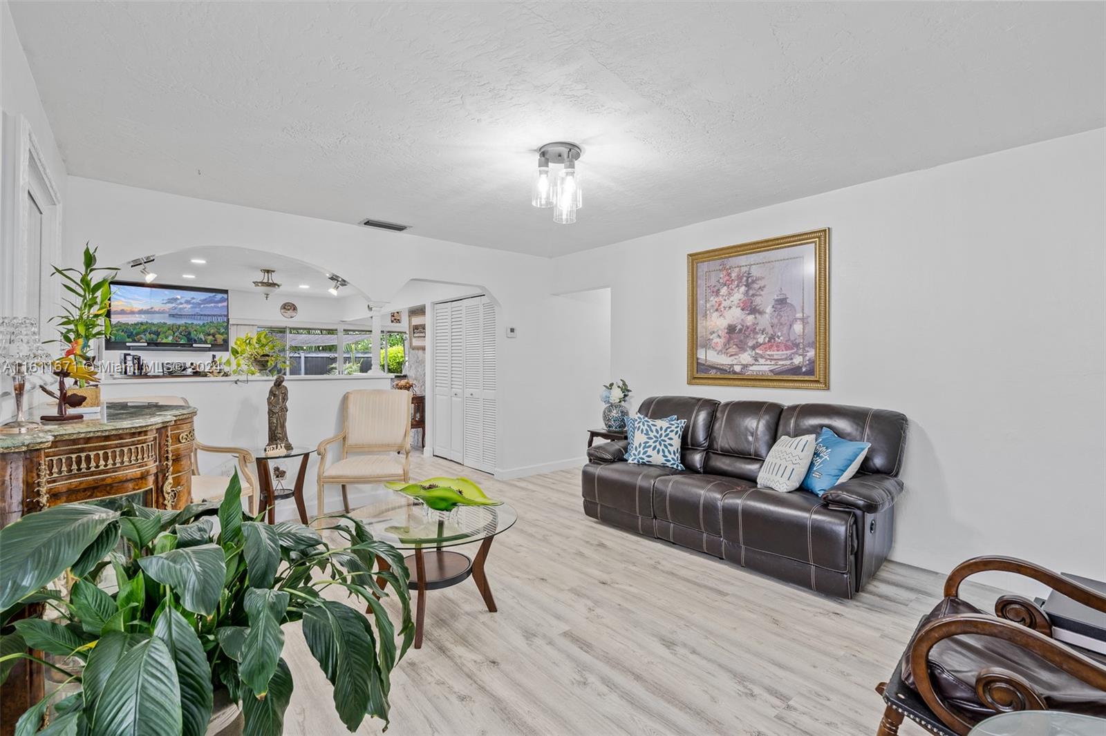 11914 Southwest 125th Place Miami, FL 33186 - Photo 5 of 31 a living room with furniture and wooden floor