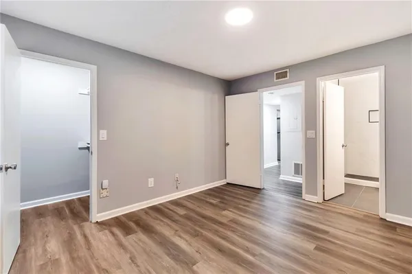 a view of wooden floor and windows in a room