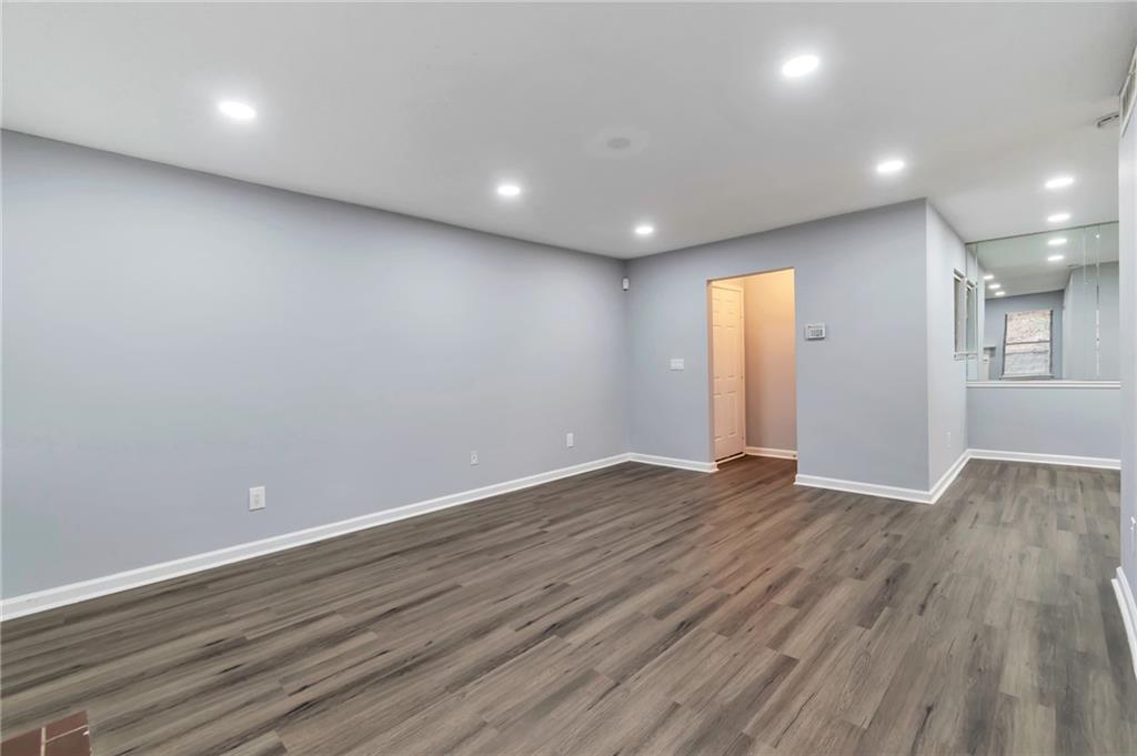 1502 Huntingdon Chase Atlanta, GA 30350 - Photo 3 of 29 an empty room with wooden floor and windows