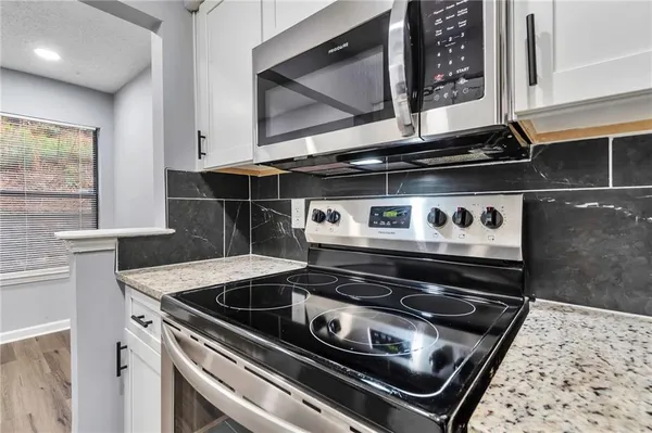 a stove top oven sitting inside of a kitchen