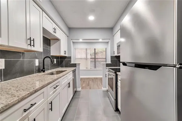 a kitchen with a refrigerator and a sink