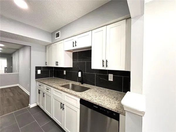 a kitchen with a sink stove and cabinets