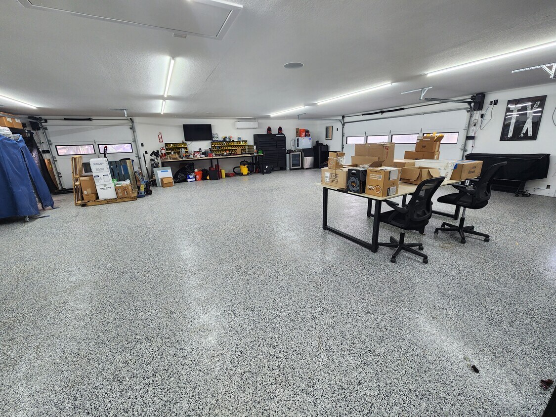 102 County Road 180 Leander, TX 78641 - Photo 12 of 25 Ample space for hobbies or storage, this vast garage boasts a pristine, speckled floor.