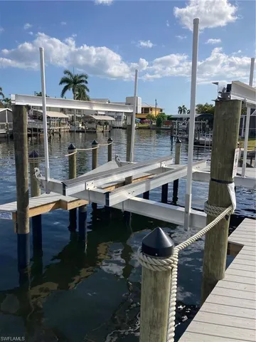 a roof deck with table and chairs