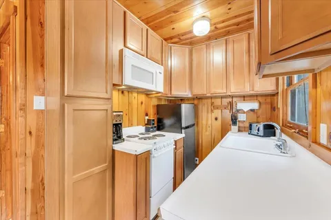 a kitchen with stainless steel appliances a refrigerator and a stove