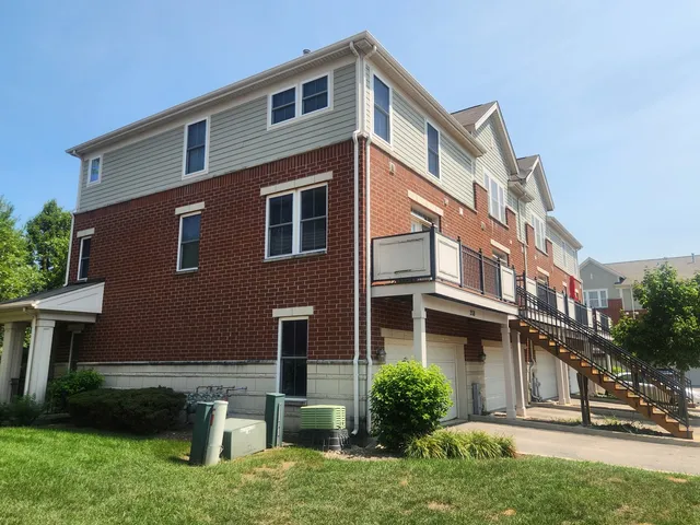 a front view of a residential apartment building with a yard