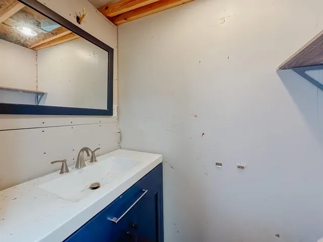 a view of empty room with window and fan