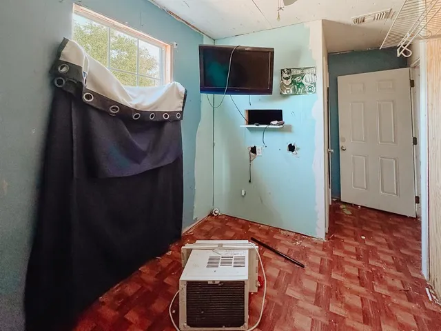 a bedroom with a bed and a lamp