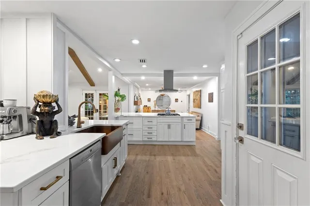 a kitchen with granite countertop a sink stainless steel appliances and cabinets