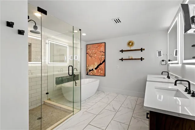 a view of a patio with a table and chairs under a large umbrella