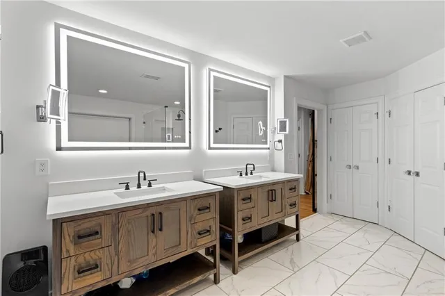 a patio with a table and chairs and potted plants
