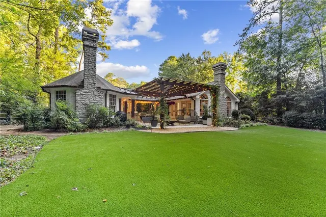 a view of a house with a yard and garage