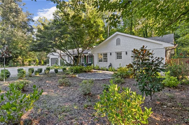 a view of a patio with a table and chairs and potted plants