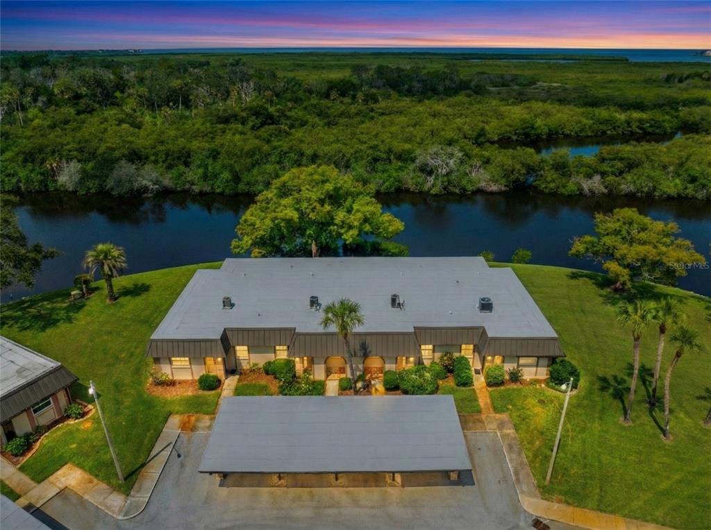 an aerial view of a house with pool lake view and mountain view