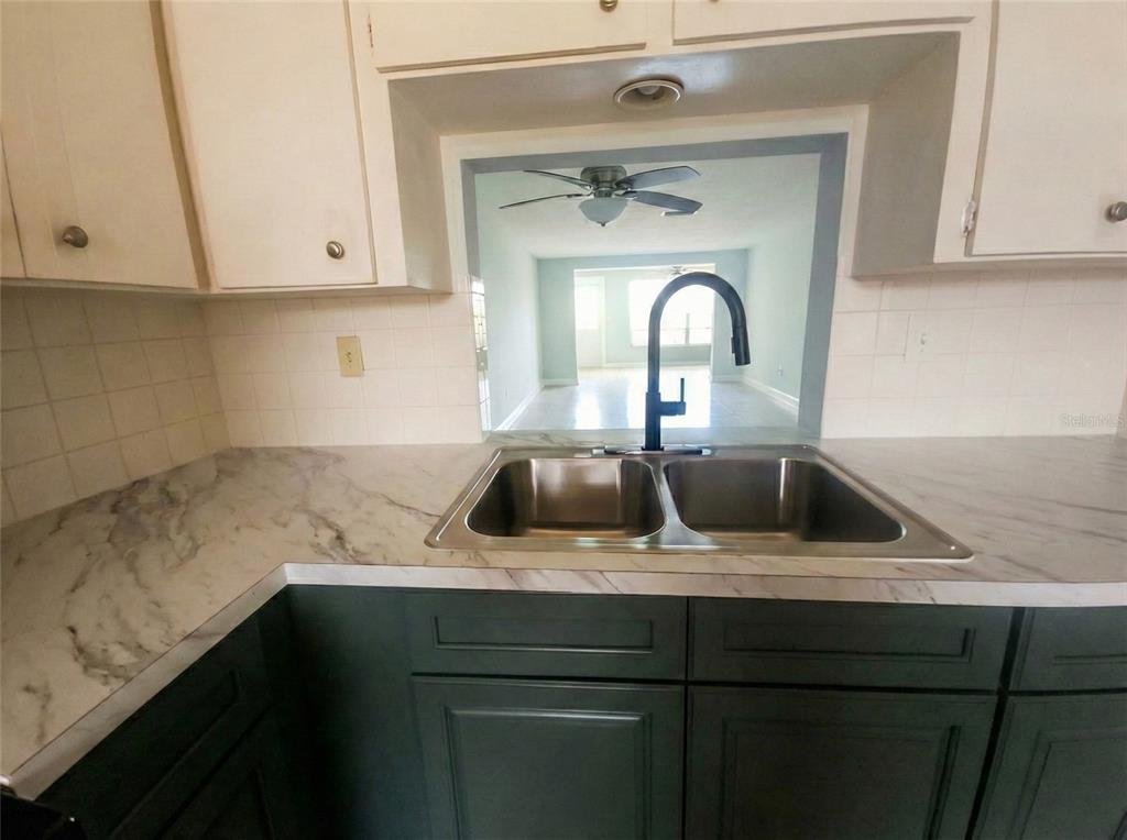 4112 Hampton Drive New Port Richey, FL 34652 - Photo 11 of 73 a kitchen with a sink and cabinets