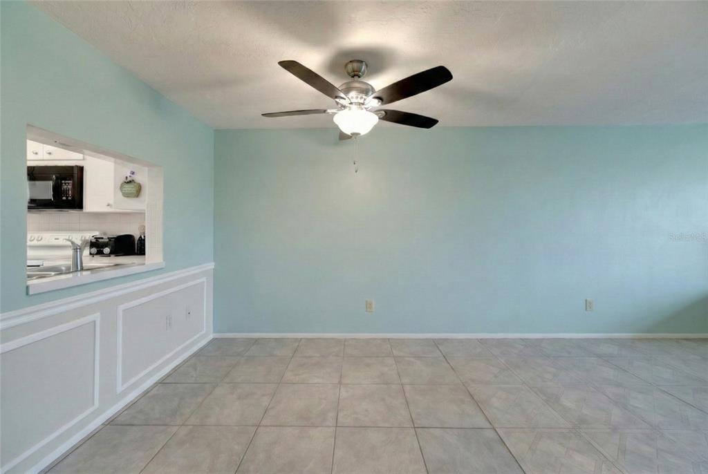 4112 Hampton Drive New Port Richey, FL 34652 - Photo 12 of 73 a very nice looking room with a ceiling fan and a rug