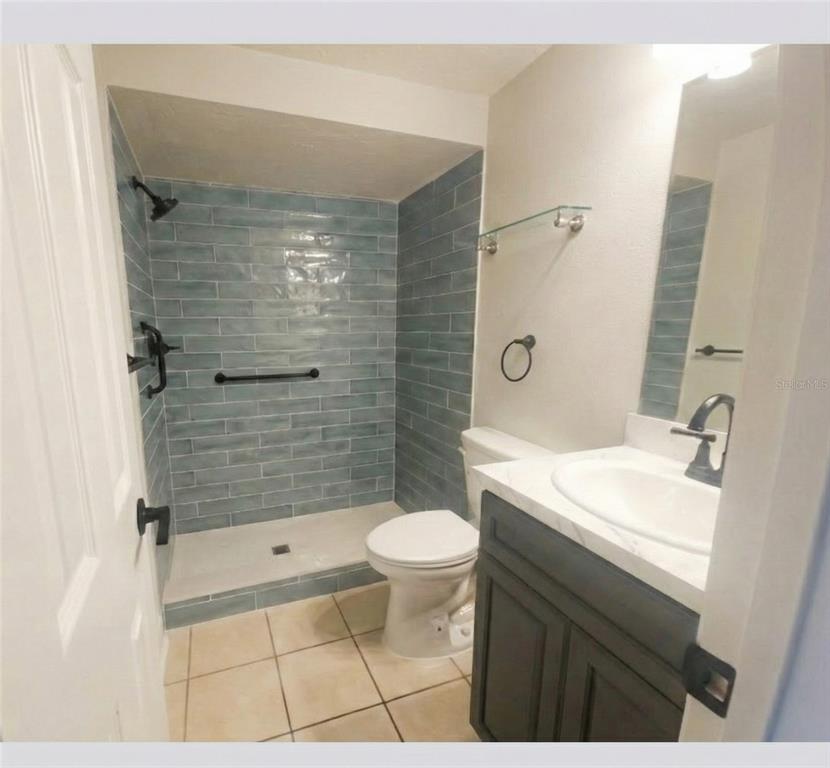 4112 Hampton Drive New Port Richey, FL 34652 - Photo 19 of 73 a bathroom with a sink a toilet and shower