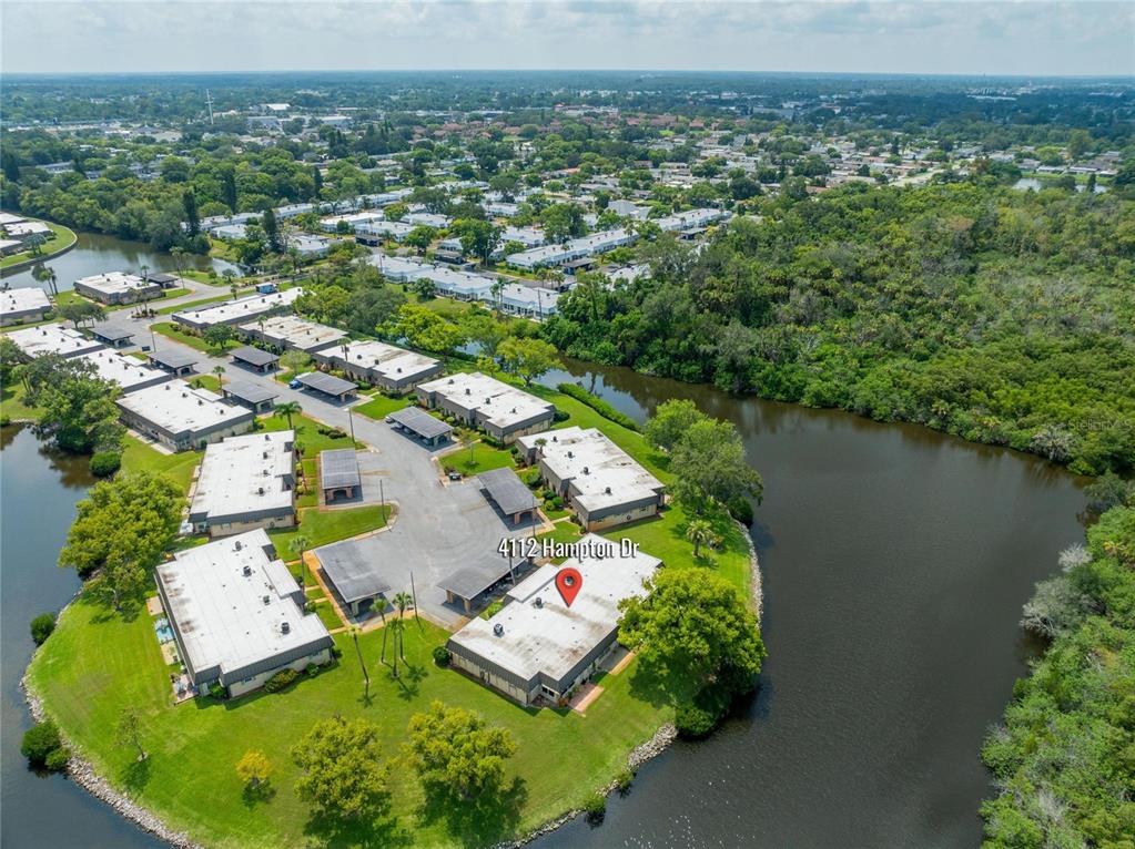 4112 Hampton Drive New Port Richey, FL 34652 - Photo 41 of 73 an aerial view of residential houses with outdoor space and trees