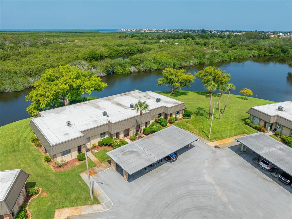 4112 Hampton Drive New Port Richey, FL 34652 - Photo 50 of 73 an aerial view of a house with a garden and lake view