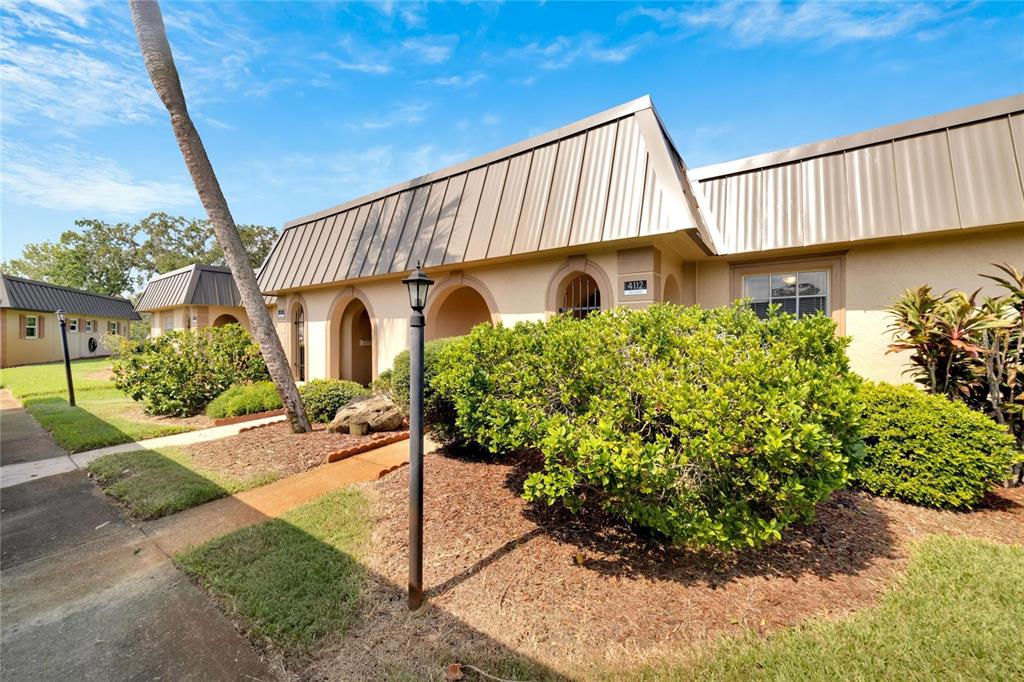 4112 Hampton Drive New Port Richey, FL 34652 - Photo 5 of 73 a view of a house with a yard and potted plants