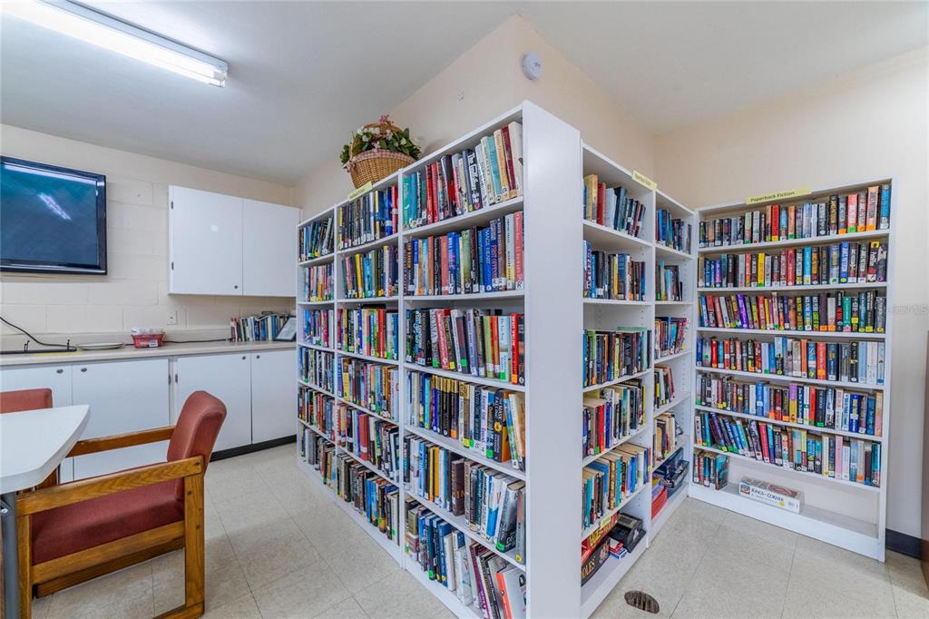4112 Hampton Drive New Port Richey, FL 34652 - Photo 56 of 73 a living room with a book shelf and a book shelf