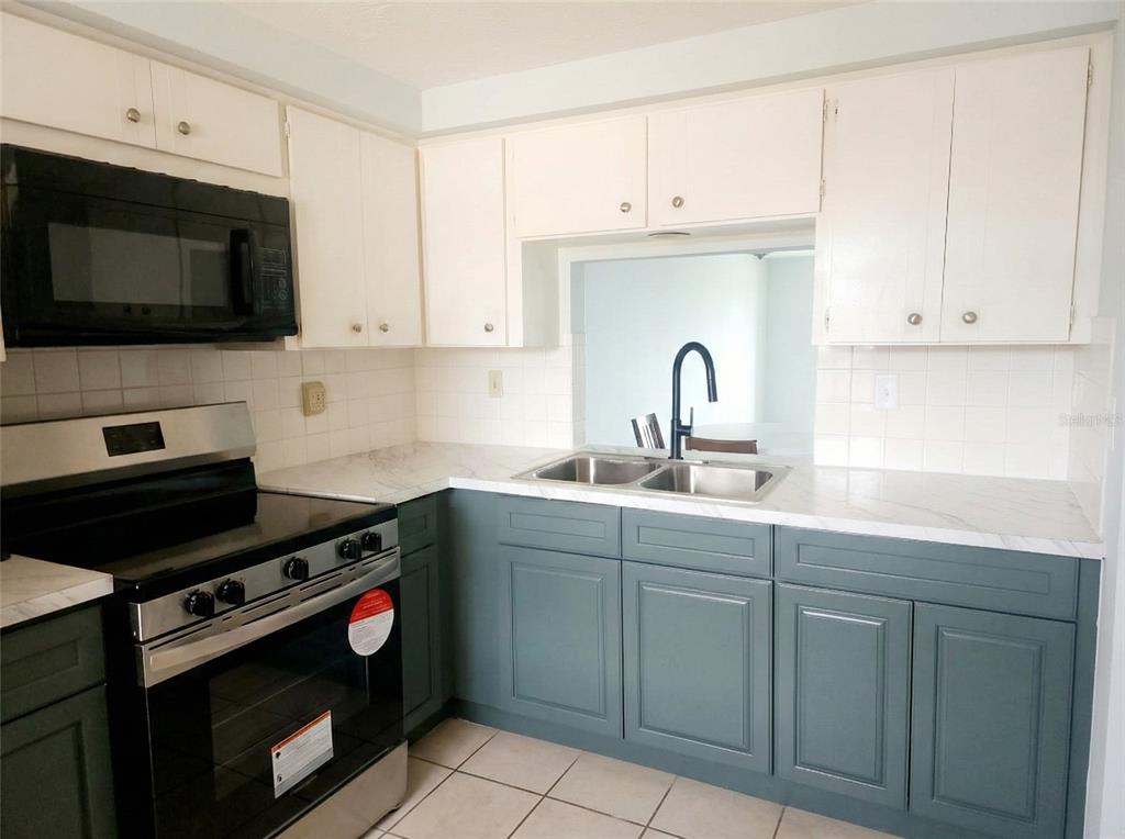4112 Hampton Drive New Port Richey, FL 34652 - Photo 10 of 73 a kitchen with granite countertop a stove and a sink