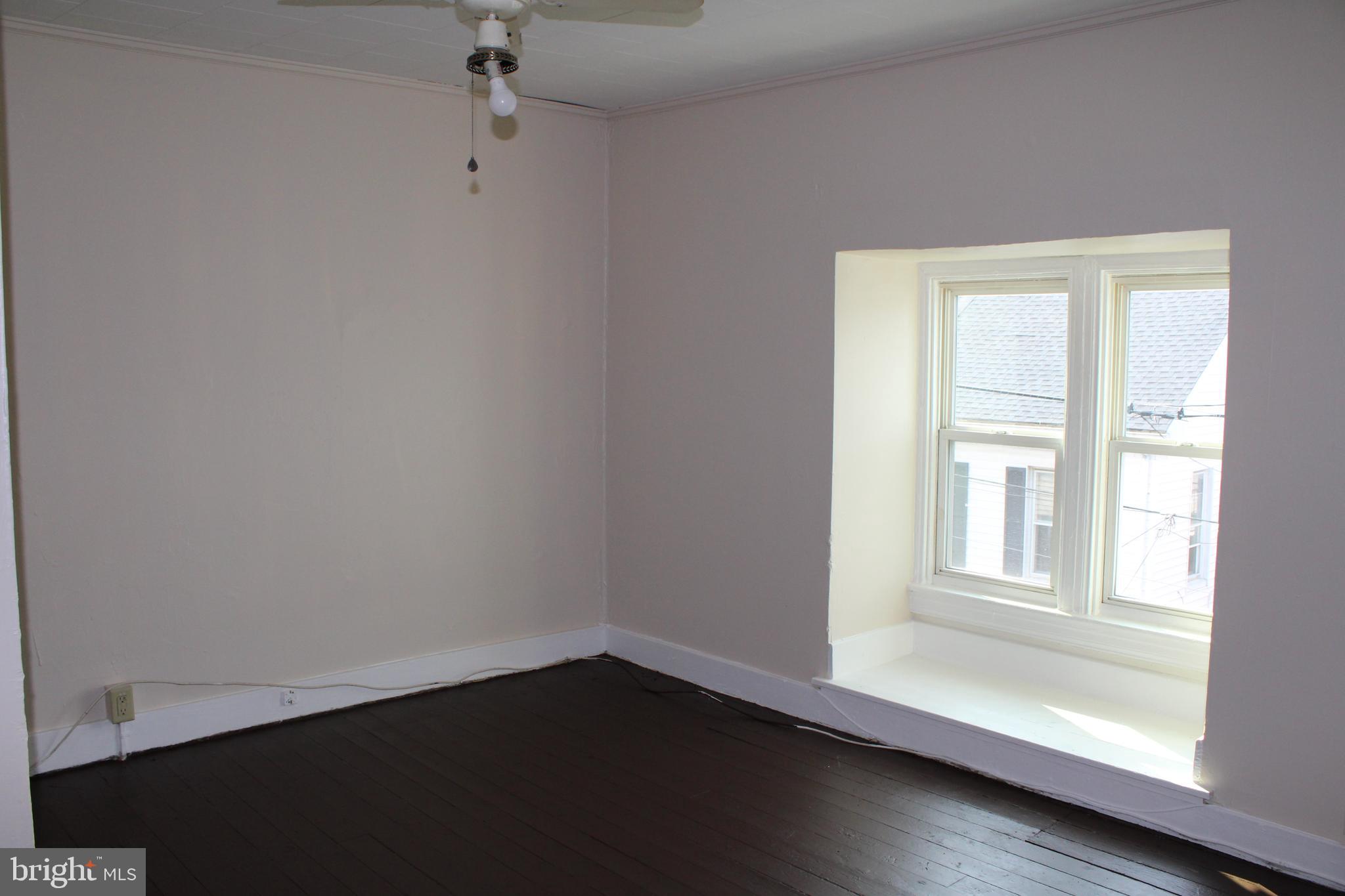 103 West 6th Avenue York, PA 17404 - Photo 17 of 19 wooden floor in an empty room with a window