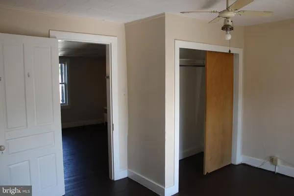 a view of a hallway with wooden floor