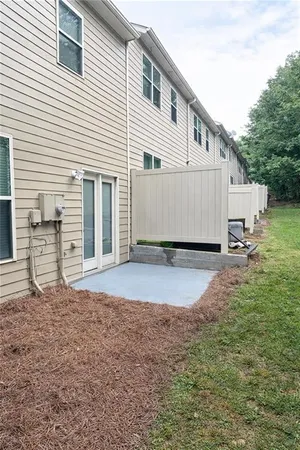 a view of a house with backyard and sitting area