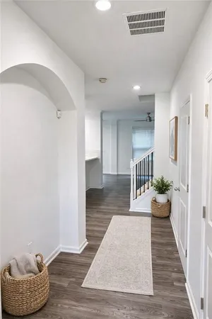 a hallway with a dining table and chairs