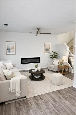 a living room with furniture and a wooden floor
