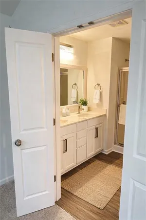 a bathroom with a granite countertop sink a mirror and a vanity