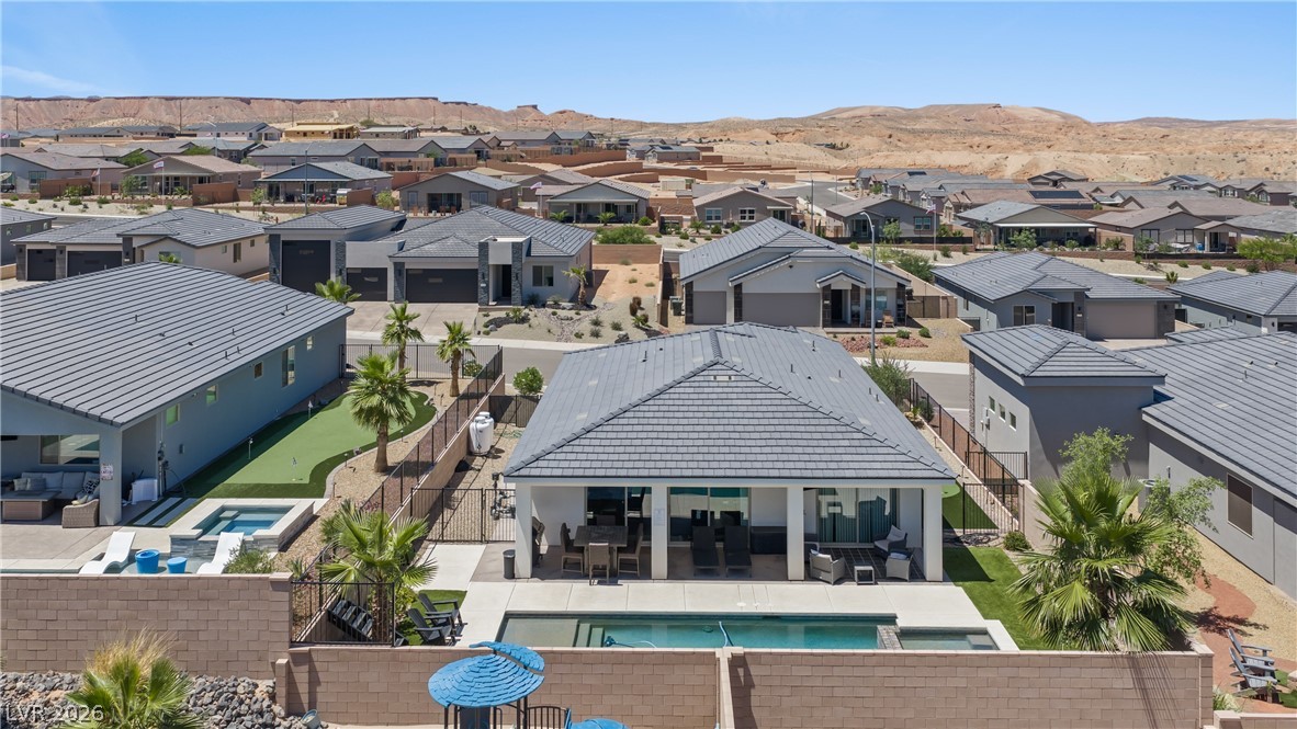 1436 Manassas Ridge Mesquite, NV 89027 - Photo 77 of 77 An aerial perspective showcases a vibrant desert community with a private pool and putting green.