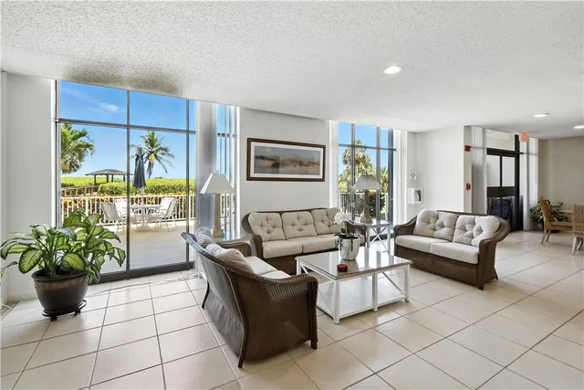 a dining room with furniture a window and a projector