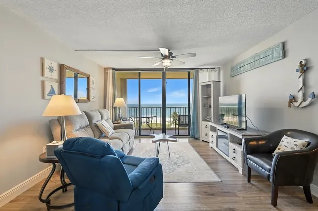 a kitchen with stainless steel appliances kitchen island granite countertop a sink cabinets and wooden floor