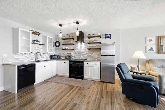 a view of a kitchen with furniture and a wooden floor