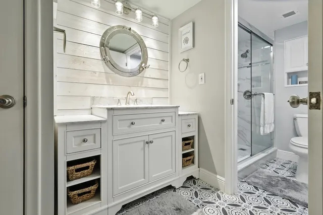 a white toilet sitting next to a shower