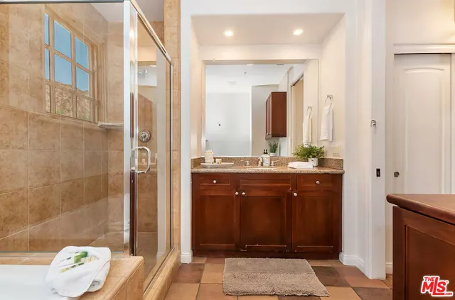 a bathroom with a sink a mirror and a shower