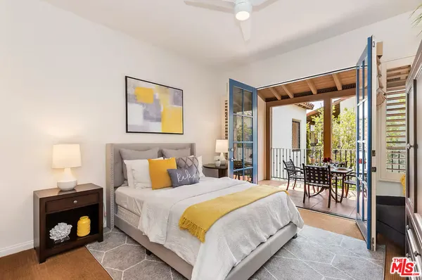 a spacious bedroom with a bed and a large window