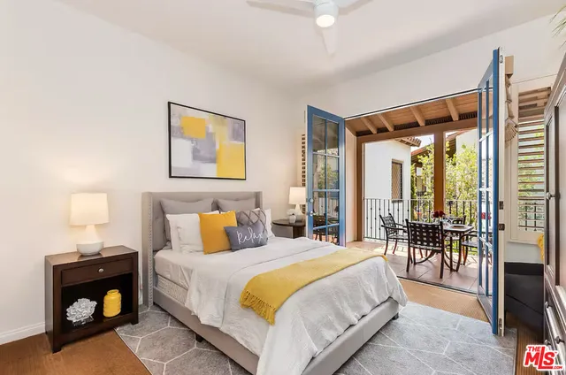 a spacious bedroom with a bed and a large window